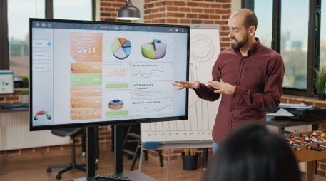 Business man planning strategy for startup presentation with asian women in boardroom, briefing colleagues about new ideas. Job partners working to develop financial collaboration.