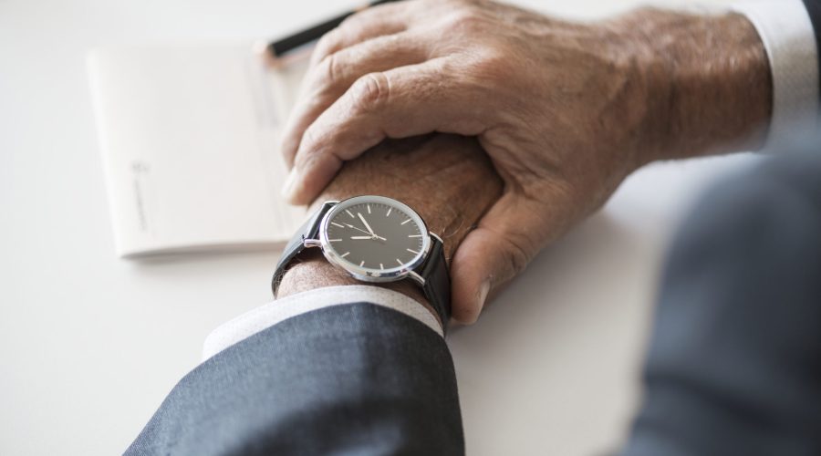 Businessman checking time on hand watch